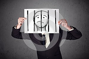 Businessman holding a paper with a prisoner behind the bars on i