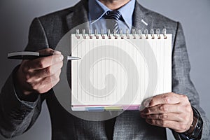 Businessman holding pen and notepad