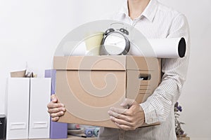 Businessman holding personal items box ready moving leaving