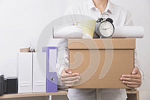 Businessman holding personal items box ready moving leaving