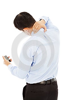 Businessman holding a phone and her neck with pain