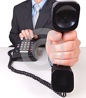 Businessman holding phone receiver