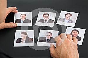 Businessman holding photograph of a candidate