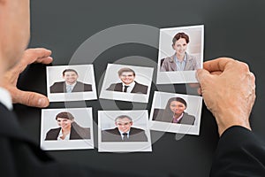 Businessman holding photograph of a candidate