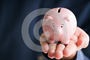 Businessman Holding Piggy Bank