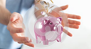 Businessman holding piggy bank with flying coins going inside 3D rendering