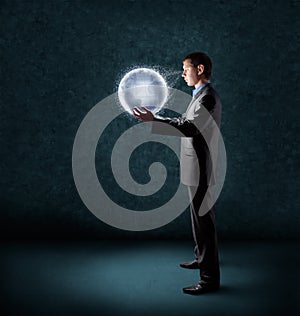 Businessman holding planet earth