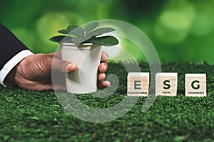 Businessman holding plant pot with ECO cube symbol. Alter