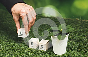 Businessman holding plant pot with ECO cube symbol. Alter