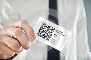 Businessman holding QR code business card