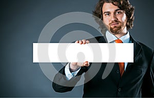 Businessman holding a rectangular blank sign