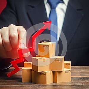 Businessman holding a red arrow up over boxes. Strategy marketing. Supply Demand. Increase sales rate, industrial goods production