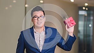 Businessman holding the red gift box