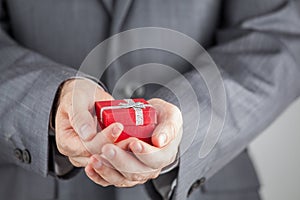 Businessman Holding Red Gift Box