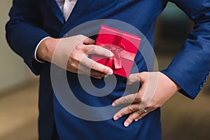 Businessman holding the red gift box