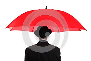 Businessman holding a red umbrella