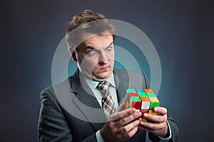 Businessman holding rubik cube in his hands