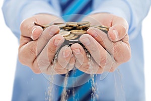 Businessman holding sand and coin