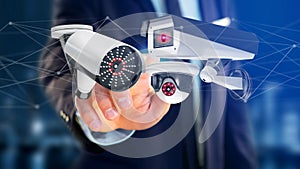 Businessman holding a Security camera system and network connect