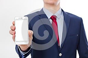 Businessman holding and showing blank screen cell phone isolated on white background. Copy space and selective focus