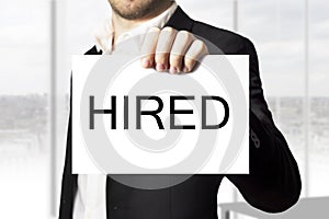 Businessman holding sign hired