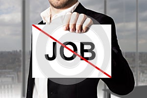 Businessman holding sign job crossed out jobless