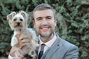 Businessman holding small dog outdoors