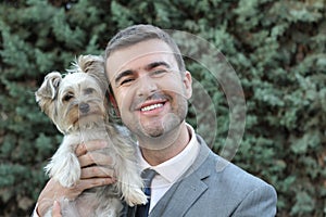 Businessman holding small dog outdoors
