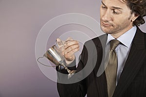 Businessman Holding Small Trophy