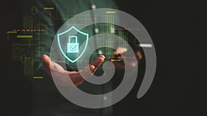 Businessman holding smartphone with digital shield and padlock hologram, representing cybersecurity, data protection?