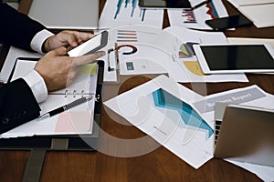 businessman holding smartphone & using app at meeting. man texting message at office. social network communication, wireless conn