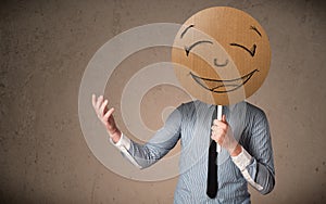 Businessman holding a smiley face board