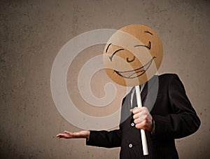 Businessman holding a smiley face board