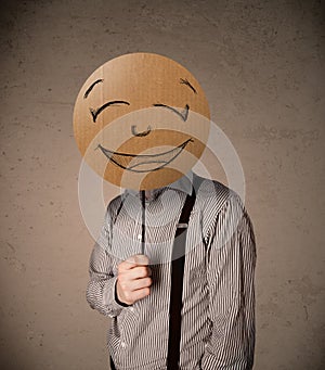 Businessman holding a smiley face board