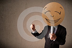 Businessman holding a smiley face board