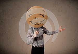 Businessman holding a smiley face board