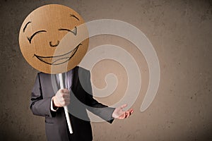 Businessman holding a smiley face board