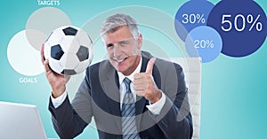 Businessman holding soccer ball while showing thumbs up