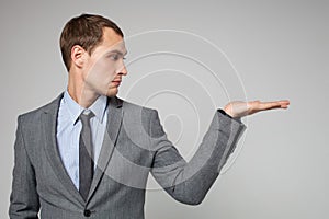 Businessman holding something imaginary in his hand and l