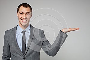 Businessman holding something imaginary in his hand and l