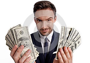 businessman holding stack of dollar money in his hands