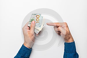 businessman holding a stack of euro banknotes in his hand, points his finger at money, income, success