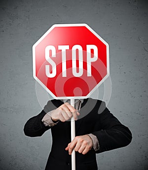 Businessman holding a stop sign