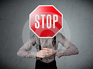 Businessman holding a stop sign