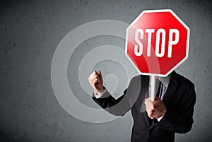 Businessman holding a stop sign