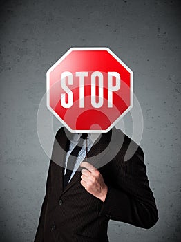 Businessman holding a stop sign