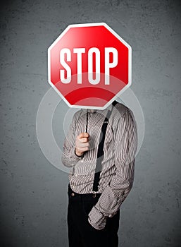 Businessman holding a stop sign