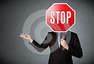 Businessman holding a stop sign