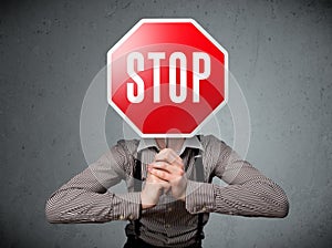 Businessman holding a stop sign