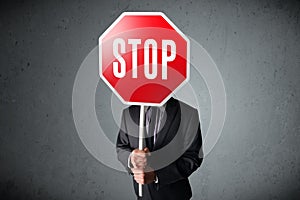 Businessman holding a stop sign